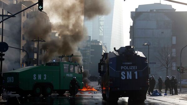 Police vehicles are seen on streets during a protest of 'Blockupy' anti-capitalist movement members near the European Central Bank (ECB) building before the official opening of its new headquarters in Frankfurt March 18, 2015. - Sputnik International
