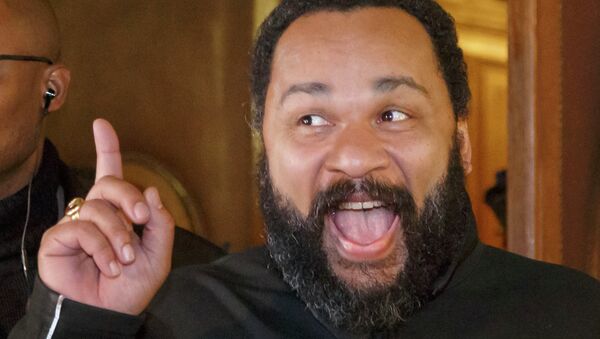 French comedian Dieudonne M'Bala M'Bala gestures to the media as he leaves a Paris court house, Wednesday, Feb. 4, 2015. Controversial French comic Dieudonne has gone on trial charged with defending terrorism in a Facebook post made after the three-day terror spree in Paris last month. - Sputnik International