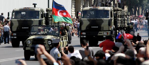 Military vehicles make their way down a road during a military parade marking Armed Forces Day in Baku, Azerbaijan, in 2011. Military vehicles make their way down a road during a military parade marking Armed Forces Day in Baku, Azerbaijan, in 2011. - Sputnik International
