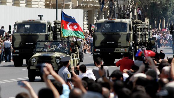 Military vehicles make their way down a road during a military parade marking Armed Forces Day in Baku, Azerbaijan, in 2011. - Sputnik International