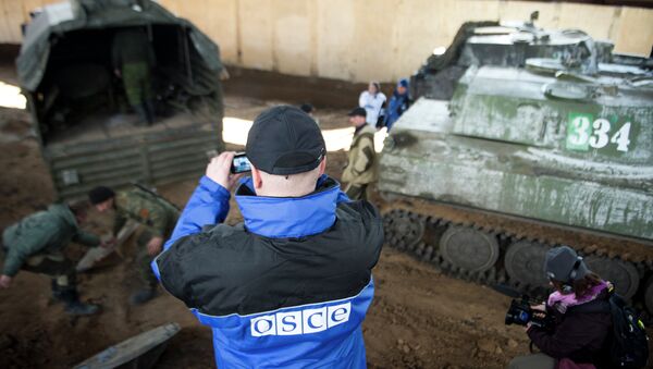 An international monitor of the Organization for Security and Co-operation in Europe (OSCE) shoots video - Sputnik International