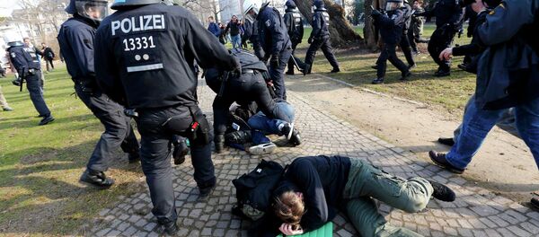 Policemen detain members of 'Blockupy' anti-capitalist movement near the European Central Bank (ECB) building before the official opening of its new headquarters in Frankfurt March 18, 2015 - Sputnik International