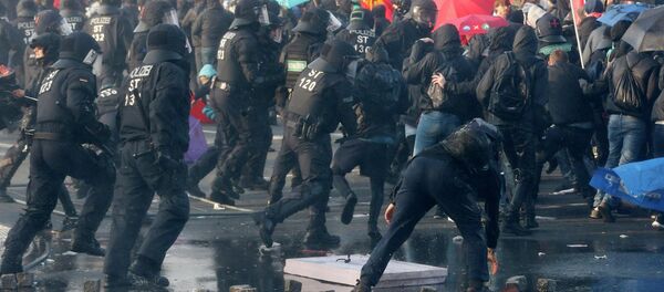 Police chase demonstrators after they threw stones Wednesday, March 18, 2015 in Frankfurt, Germany - Sputnik International