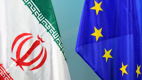An Iranian (L) and a European flag are set on March 16, 2015 - Sputnik International