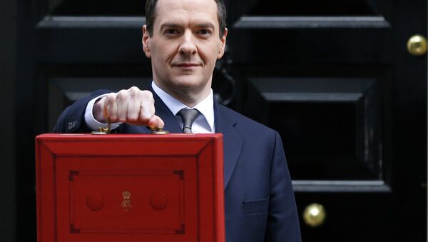 Britain's Chancellor George Osborne poses for the media with the traditional red dispatch box outside his official residence at 11 Downing Street in London - Sputnik International