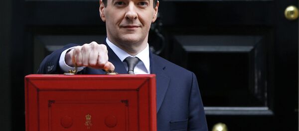 Britain's Chancellor George Osborne poses for the media with the traditional red dispatch box outside his official residence at 11 Downing Street in London - Sputnik International