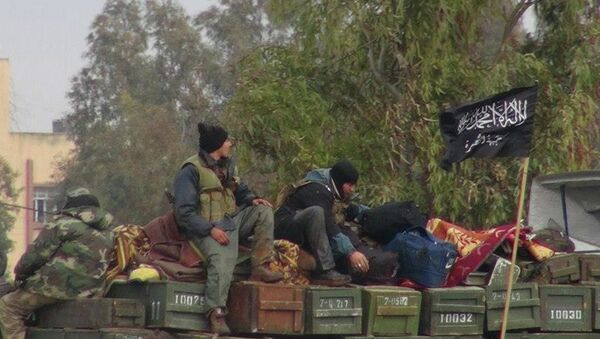 Rebels from al-Qaida affiliated al-Nusra Front, as they sit on a truck full of ammunition, at Taftanaz air base, that was captured by the rebels, in Idlib province, northern Syria - Sputnik International