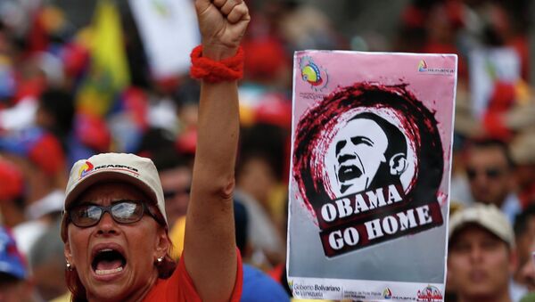 A supporter of Venezuela's President Nicolas Maduro shouts next to a placard depicting US President Barack Obama during a rally against imperialism, in Caracas March 15, 2015 - Sputnik International