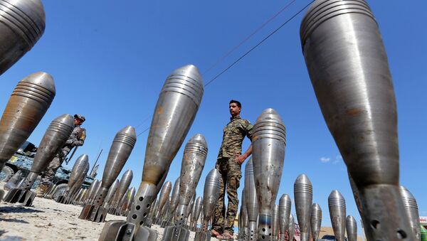 A member of the Iraqi security forces stands between Islamic State ammunition being displayed in al-Alam Salahuddin province March 17, 2015 - Sputnik International