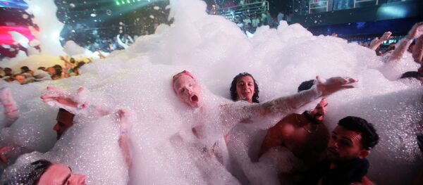 Partygoers dance in foam at The City nightclub in the Caribbean resort city of Cancun, Mexico, early Monday, March 16, 2015 - Sputnik International