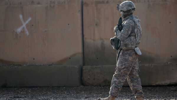 A US soldier walks at the Taji base complex which hosts Iraqi and US troops and is located thirty kilometres north of the capital Baghdad - Sputnik International