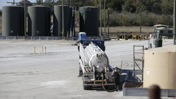 In this Wednesday, Nov. 19, 2014 photo, a fracking wastewater storage facility sits just outside the city limits of Reno, Texas - Sputnik International