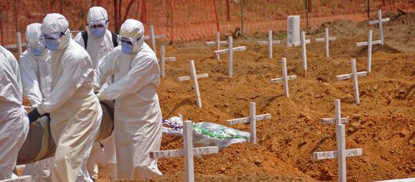 Health workers carry the body, of a person that they suspected died from the Ebola virus at a new graveyard on the outskirts of Monrovia, Liberia, Wednesday, March 11, 2015 Health workers carry the body, of a person that they suspected died from the Ebola virus at a new graveyard on the outskirts of Monrovia, Liberia, Wednesday, March 11, 2015 - Sputnik International