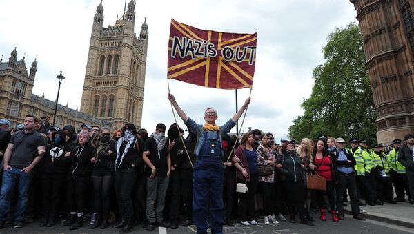 Unite Against Fascism (UAF) supporters protest during a demonstration against the British National Party (BNP) in central London. File photo - Sputnik International