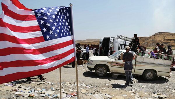 US flag waves while displaced Iraqis from the Yazidi community cross the Syria-Iraq border on Feeshkhabour bridge over Tigris River at Feeshkhabour border point, northern Iraq - Sputnik International