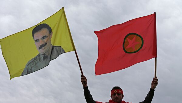 A Kurdish man waves a flag of the Kurdistan Workers' Party, known as PKK, right, and a flag with a portrait of the jailed Turkish Kurdish guerrilla leader Abdullah Ocalan, left, during a demonstration demanding his release, in Beirut, Lebanon - Sputnik International