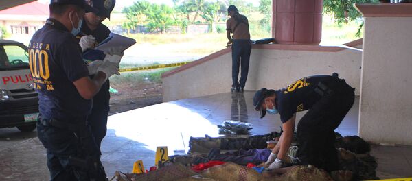 This photo taken on March 8, 2015 shows police investigators looking at dead bodies of alleged Bangsamoro Islamic Freedom Fighters (BIFF) - Sputnik International