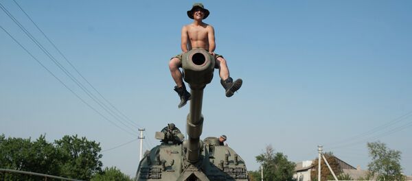 Ukrainian soldier sits atop of a self-propelled gun as an army column of military vehicles prepares to roll to a frontline near Illovaisk, Donetsk region, eastern Ukraine Ukrainian soldier sits atop of a self-propelled gun as an army column of military vehicles prepares to roll to a frontline near Illovaisk, Donetsk region, eastern Ukraine - Sputnik International