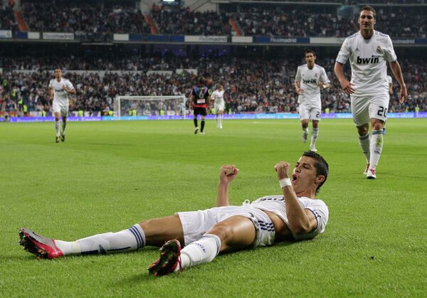 Real Madrid's Cristiano Ronaldo from Portugal celebrates after scoring against Racing Santander during a Spanish La Liga soccer match at the Santiago Bernabeu stadium in Madrid Real Madrid's Cristiano Ronaldo from Portugal celebrates after scoring against Racing Santander during a Spanish La Liga soccer match at the Santiago Bernabeu stadium in Madrid - Sputnik International