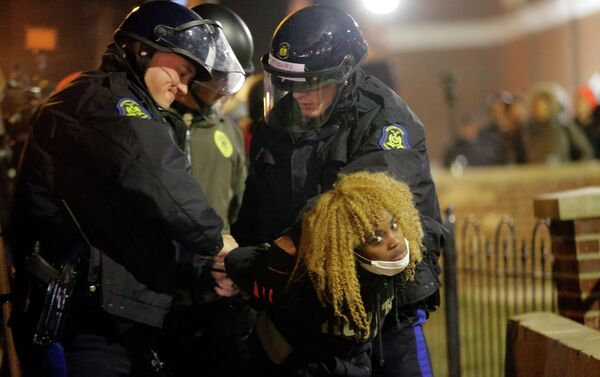 Police officers take a protester into custody Tuesday, Nov. 25, 2014, in Ferguson, Mo. - Sputnik International