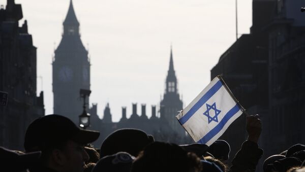 A demonstrator holds aloft an Israeli flag during a rally in Trafalgar Square in London - Sputnik International