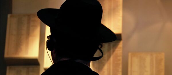 An Ultra-Orthodox Jewish man looks at facsimiles of Oskar Schindler's lists displayed for the public at the Yad Vashem Holocaust memorial museum in Jerusalem An Ultra-Orthodox Jewish man looks at facsimiles of Oskar Schindler's lists displayed for the public at the Yad Vashem Holocaust memorial museum in Jerusalem - Sputnik International