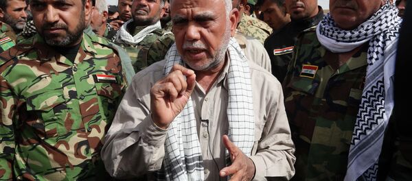 Hadi al-Amiri commander, center, of Iraq's powerful Shiite militias speaks during an interview with The Associated Press on the battlefield near the Iraqi city of Tikrit, 80 miles (130 kilometers) north of Baghdad, Iraq, Friday, March 13, 2015. Al-Amiri accused the U.S. of falling short on promises to help Iraq in its battle against the Islamic State group and called Iranian assistance to Iraqi security forces unconditional. - Sputnik International
