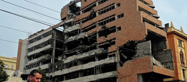 A man walks past the building of former federal military headquarters in Belgrade on March 24, 2010, destroyed during the 1999 NATO air campaign against Yugoslavia. - Sputnik International
