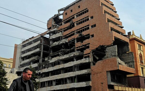 A man walks past the building of former federal military headquarters in Belgrade on March 24, 2010, destroyed during the 1999 NATO air campaign against Yugoslavia. - Sputnik International