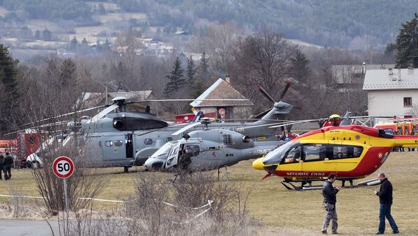 Helicopters of the French Air Force (back) and civil security services are seen in Seyne, south-eastern France, on March 24, 2015, near the site where a Germanwings Airbus A320 crashed in the French Alps. - Sputnik International