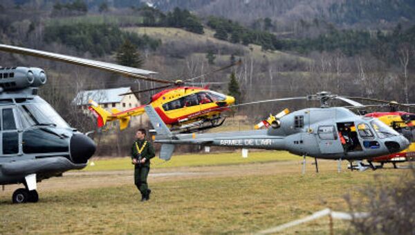 Helicopters of the French Air Force (back) and civil security services are seen in Seyne, south-eastern France, on March 24, 2015, near the site where a Germanwings Airbus A320 crashed in the French Alps. - Sputnik International