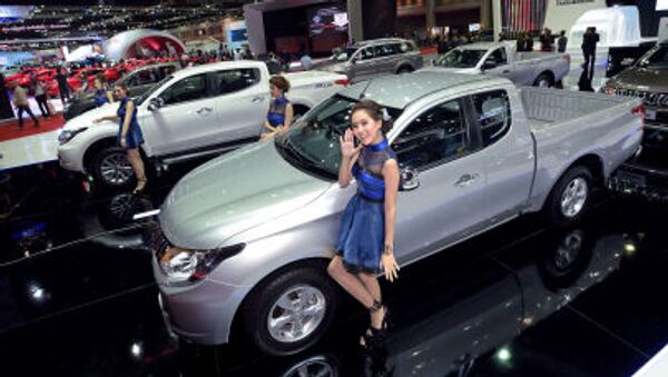 Models pose next to cars displayed at the 36th Bangkok International Motor Show on March 24, 2015 - Sputnik International