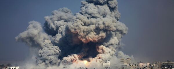 In this July 29, 2014 photo, smoke and fire from an Israeli strike rise over Gaza City. A fierce debate is raging within Israel's military over the extent to which soldiers should be held legally accountable for their actions during last year's Gaza war, with commanders increasingly at odds with military lawyers. In this July 29, 2014 photo, smoke and fire from an Israeli strike rise over Gaza City. A fierce debate is raging within Israel's military over the extent to which soldiers should be held legally accountable for their actions during last year's Gaza war, with commanders increasingly at odds with military lawyers. - Sputnik International