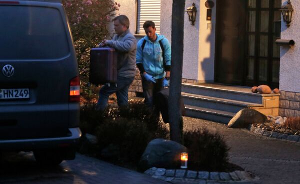 Investigators carry a suitcase out of the home of the family of Andreas Lubitz in Montabaur, Germany Investigators carry a suitcase out of the home of the family of Andreas Lubitz in Montabaur, Germany - Sputnik International