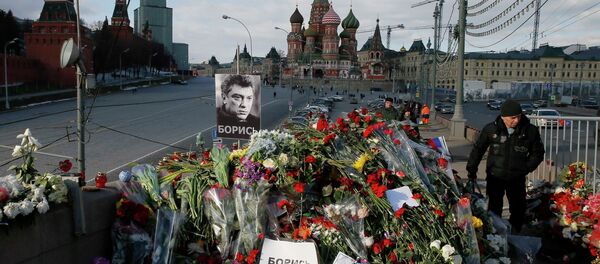 A man walks past flowers at the site where Kremlin critic Boris Nemtsov was murdered on February 27, at the Great Moskvoretsky Bridge, with St. Basil's Cathedral seen in the background, in central Moscow March 6, 2015 A man walks past flowers at the site where Kremlin critic Boris Nemtsov was murdered on February 27, at the Great Moskvoretsky Bridge, with St. Basil's Cathedral seen in the background, in central Moscow March 6, 2015 - Sputnik International
