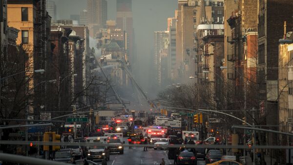 New York City Fire Department firefighters and emergency personnel respond at the site of a residential apartment building which had collapsed and was engulfed in flames in New York City's East Village neighborhood - Sputnik International