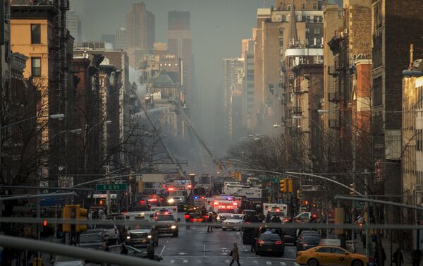 New York City Fire Department firefighters and emergency personnel respond at the site of a residential apartment building which had collapsed and was engulfed in flames in New York City's East Village neighborhood - Sputnik International