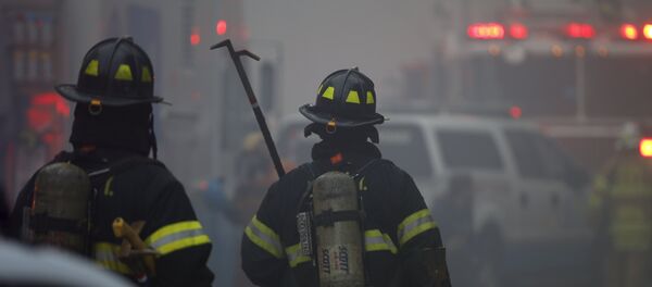 New York City Fire Department firefighters walk towards the site of a residential apartment building collapse and fire in New York City's East Village neighborhood New York City Fire Department firefighters walk towards the site of a residential apartment building collapse and fire in New York City's East Village neighborhood - Sputnik International