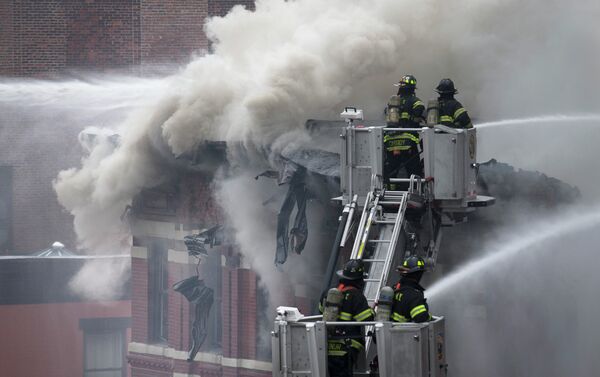 Firefighters spray water on a collapsed building in New York's East Village - Sputnik International