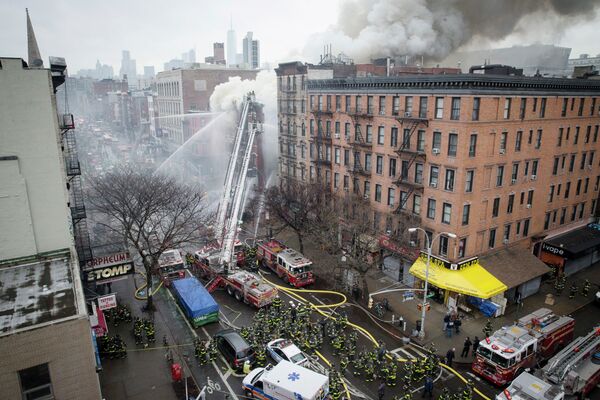 New York City firefighters work the scene of a large fire and a partial building collapse in the East Village neighborhood of New York New York City firefighters work the scene of a large fire and a partial building collapse in the East Village neighborhood of New York - Sputnik International