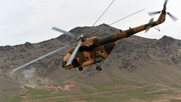 An Afghanistan National Army (ANA) helicopter flies over a military base as commando forces demonstrate their skills during an exercise mission at Commando Unit Base on outskirts of Kabul on March 16, 2013 - Sputnik International