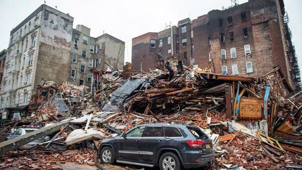 A pile of debris remains at the site of a building explosion in the East Village neighborhood of New York, Friday, March 27, 2015 - Sputnik International