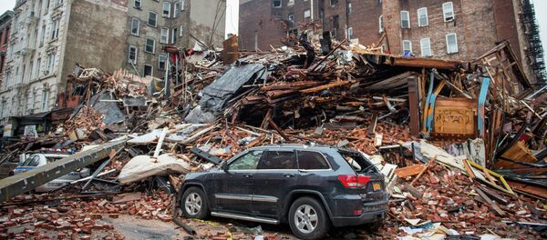 A pile of debris remains at the site of a building explosion in the East Village neighborhood of New York, Friday, March 27, 2015 - Sputnik International