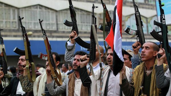 Shiite rebels, known as Houthis, hold up their weapons to protest against Saudi-led airstrikes, during a rally in Sanaa, Yemen, Thursday, March 26, 2015 - Sputnik International