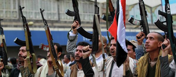 Shiite rebels, known as Houthis, hold up their weapons to protest against Saudi-led airstrikes, during a rally in Sanaa, Yemen, Thursday, March 26, 2015 - Sputnik International