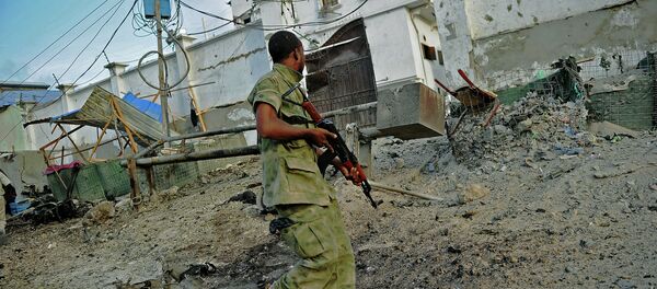 A solder walks past at the scene of a car bomb attack and armed raid by Al Shebab militants on the Maka al Mukarama hotel in Mogadishu A solder walks past at the scene of a car bomb attack and armed raid by Al Shebab militants on the Maka al Mukarama hotel in Mogadishu - Sputnik International