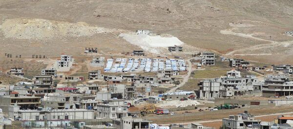 A general view shows a makeshift settlement for Syrian refugees (C, rear) on the outskirts of Arsal March A general view shows a makeshift settlement for Syrian refugees (C, rear) on the outskirts of Arsal March - Sputnik International