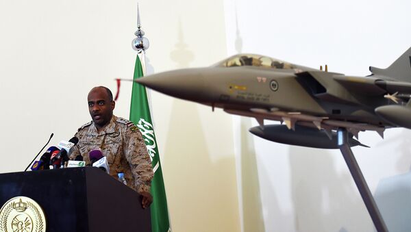 Saudi Brigadier General Ahmed Asiri, spokesman of the Saudi-led coalition forces, speaks to the media next to a replica of a Tornado fighter jet, at the Riyadh airbase in the Saudi capital on March 26, 2014 - Sputnik International