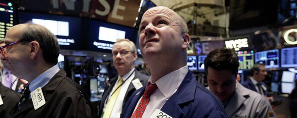 Trader Patrick Casey works on the floor of the New York Stock Exchange Trader Patrick Casey works on the floor of the New York Stock Exchange - Sputnik International
