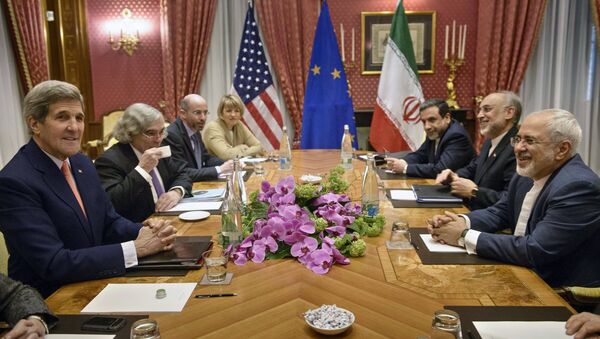 U.S. Secretary of State John Kerry (L), U.S. Secretary of Energy Ernest Moniz (2nd L), the head of the Iranian Atomic Energy Organization Ali Akbar Salehi (2nd R) and Iranian Foreign Minister Javad Zarif (R) wait with others for a meeting at the Beau Rivage Palace Hotel March 28, 2015, in Lausanne - Sputnik International